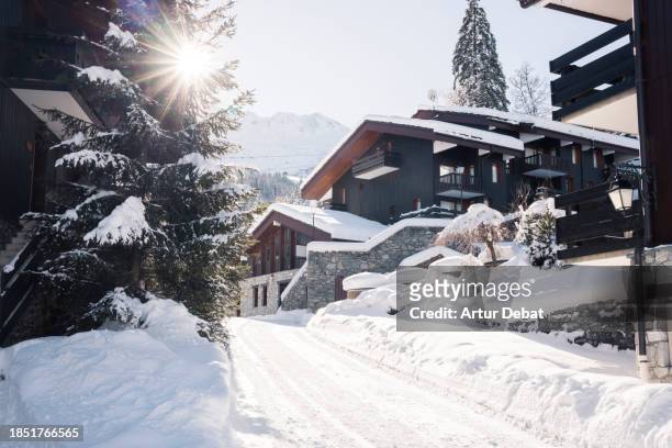 winter wonderland in a french alpine town covered in deep snow with sunlight. - french stock pictures, royalty-free photos & images