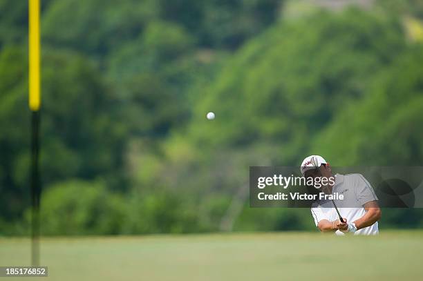 Yeh Chang-ting of Taiwan chips into the 14th green during day two of the Venetian Macau Open at Macau Golf and Country Club on October 18, 2013 in...