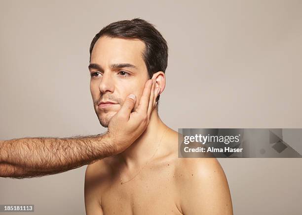 hairy man's arm holding another mans face - choker necklace stock pictures, royalty-free photos & images