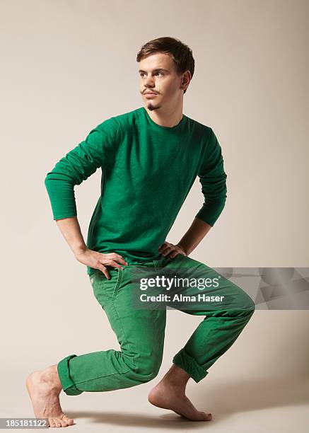 young man with moustache in green clothes - green jumper stock pictures, royalty-free photos & images