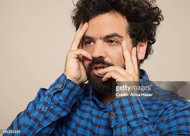man in blue shirt posing seductively with hands - desire foto e immagini stock