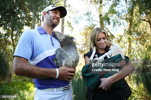 Dustin Johnson of the USA nurses a Koala with his partner Paulina Gretzky as she nurses a Joey during day two of the Perth International at Lake...