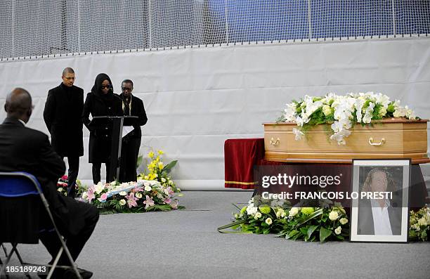 The widow of French football coach Bruno Metsu, Viviane Metsu next to relatives speaks in front of his coffin during his funeral ceremony on October...