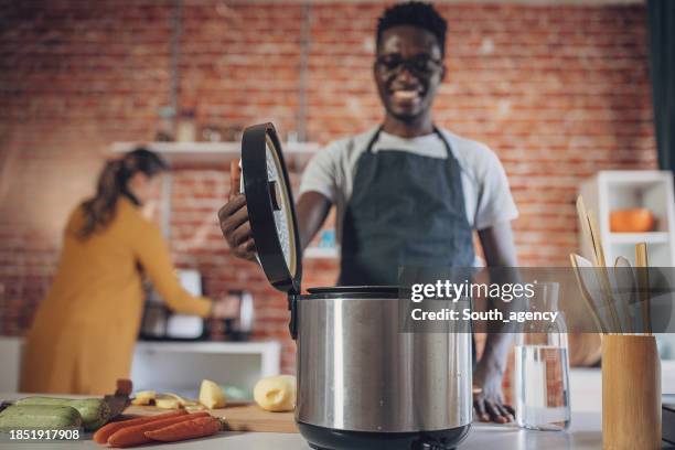 joyful cooking time with pressure cooker - pressure cooker stock pictures, royalty-free photos & images