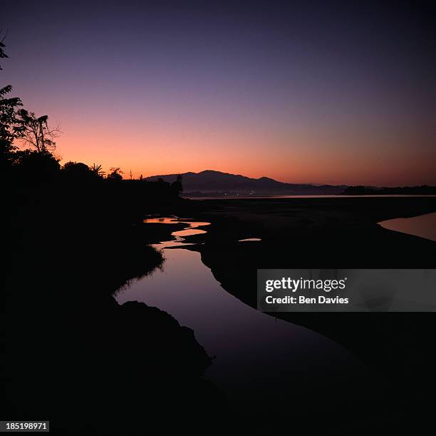 Sunset over the Mekong River near Sangkhom in Northeast Thailand during the dry season when water levels drop sharply. New dams built further upriver...