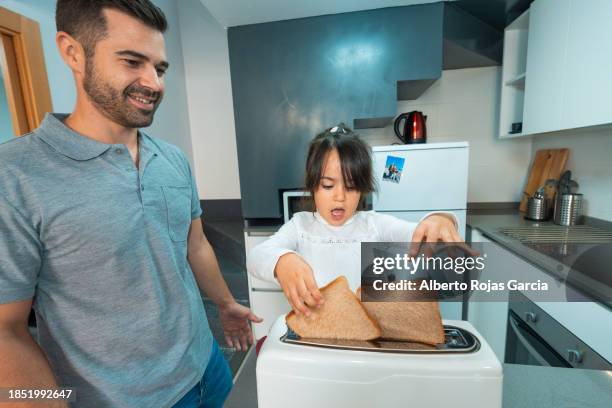 father and daughter preparing toasts for breakfast - girl making sandwich stock pictures, royalty-free photos & images