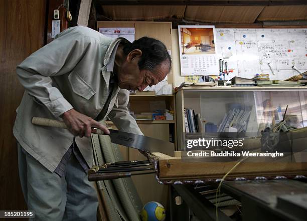 Japanese professional Tatami mat manufacturer Taizo Motoyama makes a Tatami at Motoyama Tatami Shop on October 18, 2013 in Kyoto, Japan. Tatami mat...