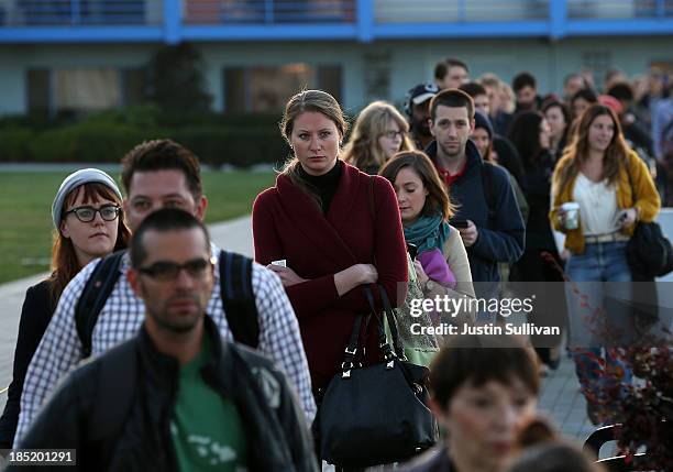 Commuters line up to board the San Francisco Bay Ferry on the first day of the Bay Area Rapid Transit strike on October 18, 2013 in Oakland,...