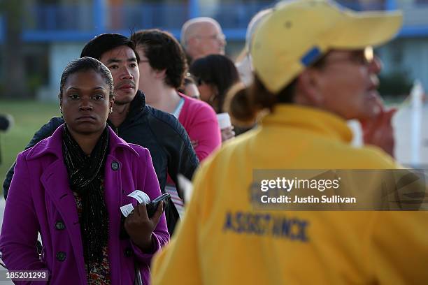 Commuters line up to board the San Francisco Bay Ferry on the first day of the Bay Area Rapid Transit strike on October 18, 2013 in Oakland,...