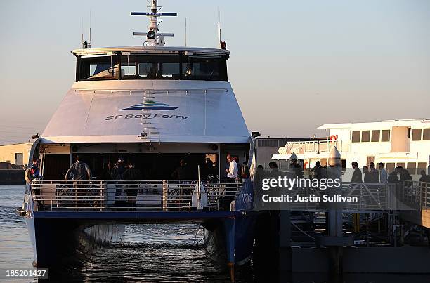 Commuters board the San Francisco Bay Ferry on the first day of the Bay Area Rapid Transit strike on October 18, 2013 in Oakland, California. For the...