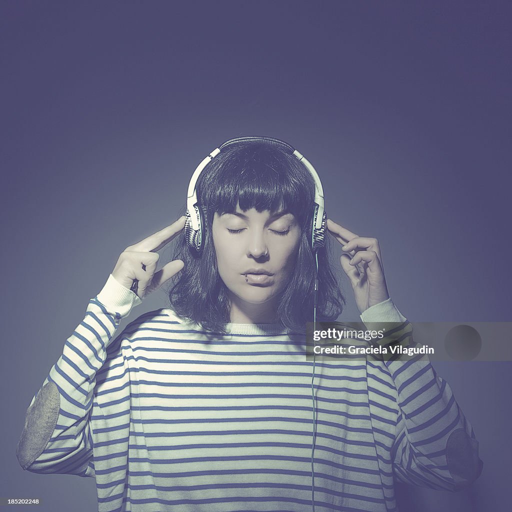 Girl with closed eyes with headphones