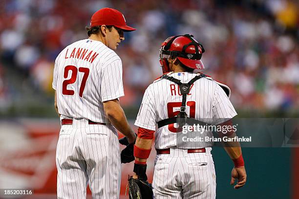 Carlos Ruiz of the Philadelphia Phillies meets on the mound with John Lannan during the game against the San Francisco Giants at Citizens Bank Park...