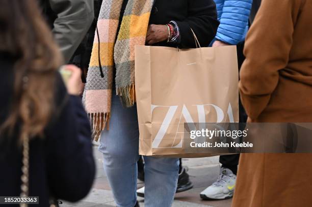 Shopper carrying a Zara branded fashion retail store carrier bag in Knightsbridge on December 11, 2023 in London, United Kingdom.