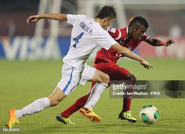 Akramjon Komilov of Uzbekistan tries to tackle Milciades Molina of Panama during the Group C, FIFA U-17 World Cup between Panama and Uzbekistan at...