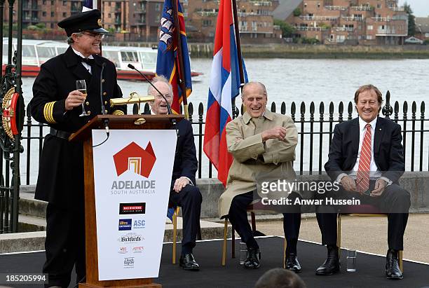 Prince Philip, Duke of Edinburgh and Bill Muirhead , Agent General of South Australia, laugh as Honorary Captain Andrew Chapman prepares to throw...