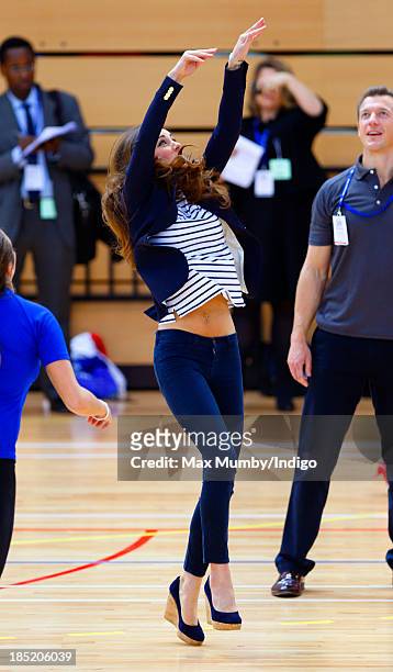 Catherine, Duchess of Cambridge plays volleyball as she attends a SportsAid Athlete Workshop in the Copper Box Arena at the Queen Elizabeth Olympic...