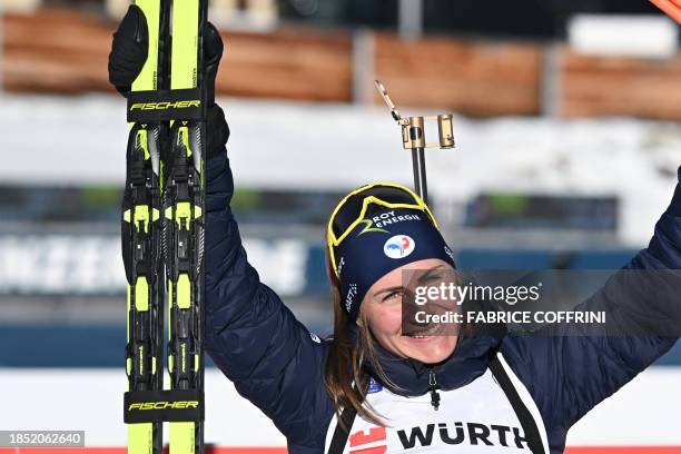 Winner France's Justine Braisaz-Bouchet celebrates on the podium of the women's 10km pursuit during the IBU Biathlon World Cup in Lenzerheide,...