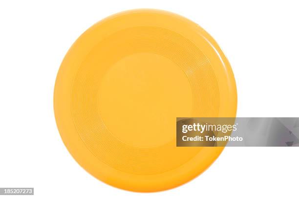 bright yellow frisbee on white background - flying disc stock pictures, royalty-free photos & images