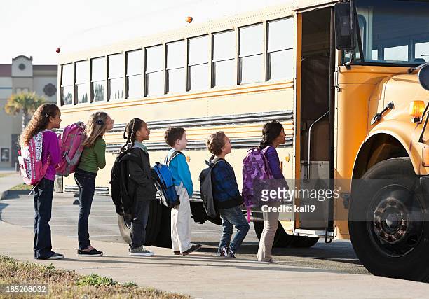 children boarding school bus - kids lining up stock pictures, royalty-free photos & images