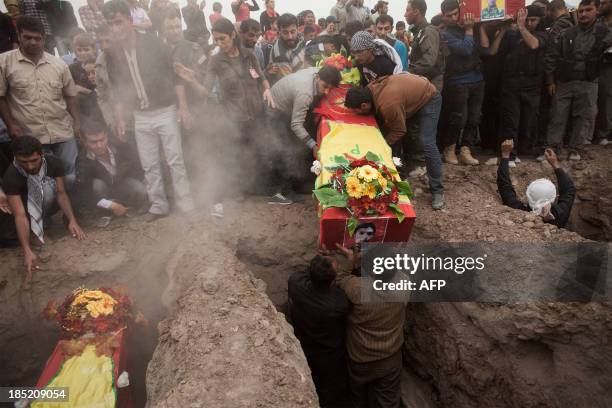 Relatives attend the funeral of four fighters of the Committees for the Protection of the Kurdish People killed in the fighting against Jabat al...