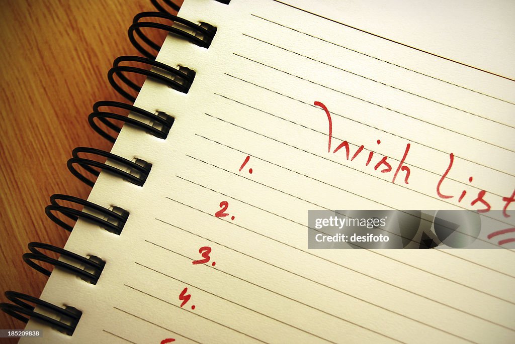 'Wish list' written on a spiral pad