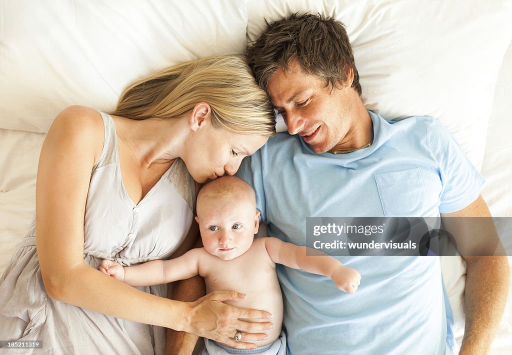 Parents With Baby In Bed