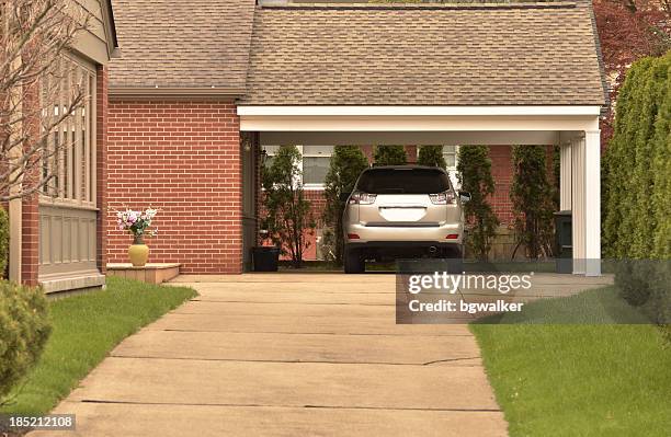 carport with parked car and nicely maintained grounds - garage stock pictures, royalty-free photos & images