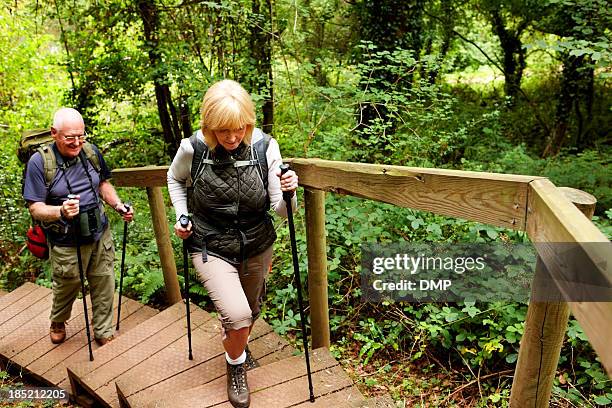 Senior couple hiking across countryside