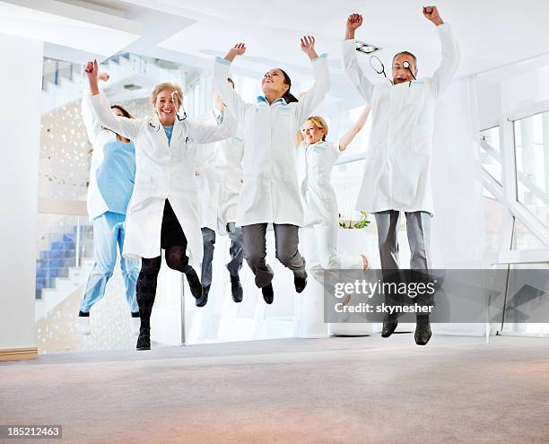 successes team of doctors. - doctor arms raised stock pictures, royalty-free photos & images