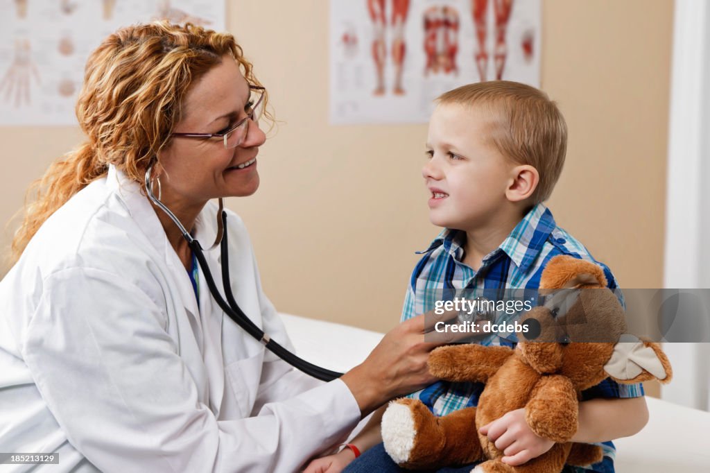 Doctor Using Stethoscope With Young Male Patient