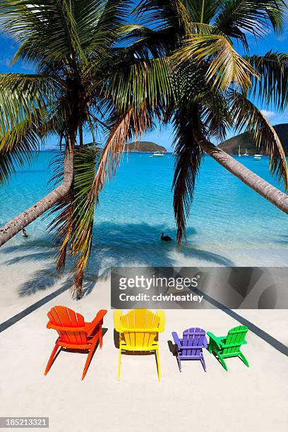 colorful andirondack chairs at a beach in the caribbean - adirondack chair stockfoto's en -beelden