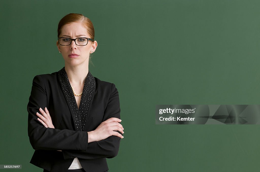 Strict teacher at blackboard