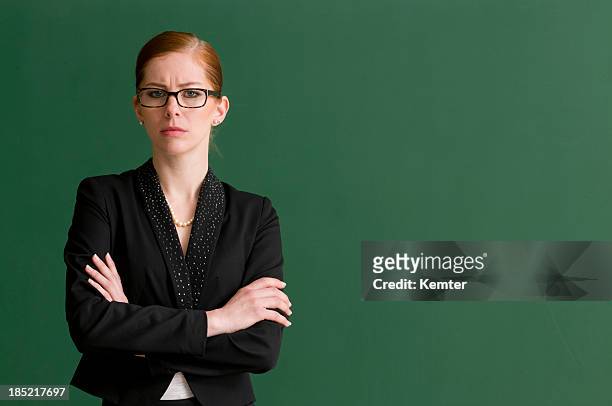 strict teacher at blackboard - isolated women serieus sad stockfoto's en -beelden