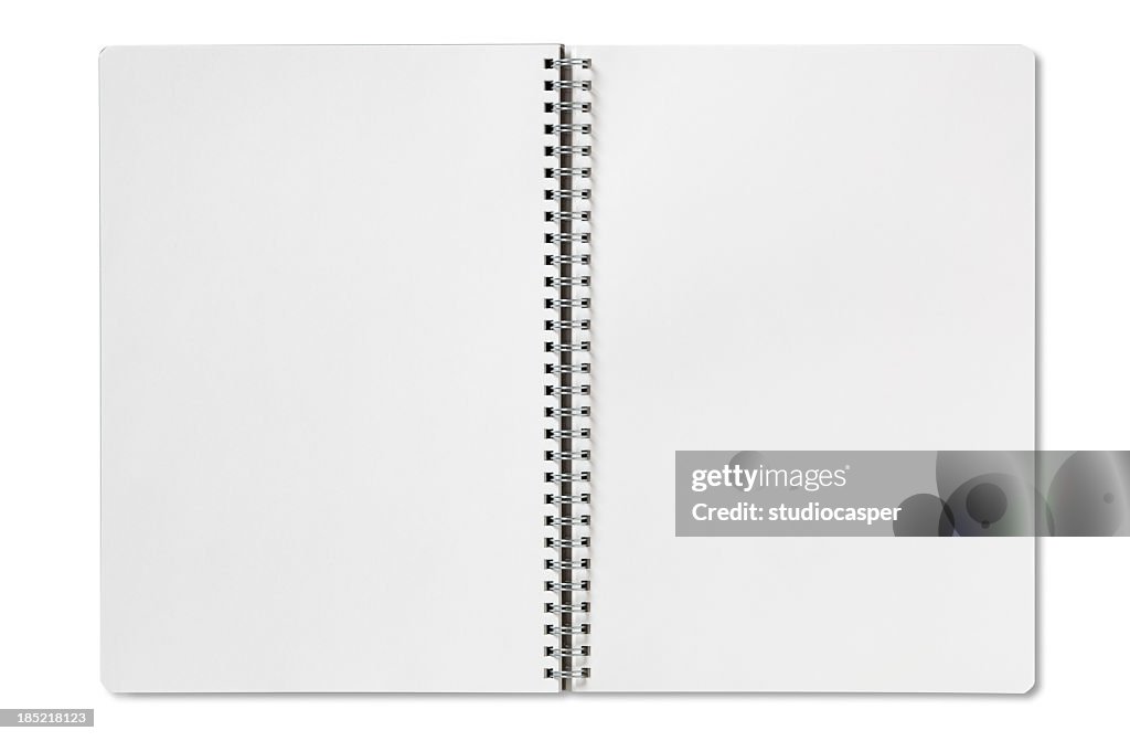 Open blank spiral notebook on a white background