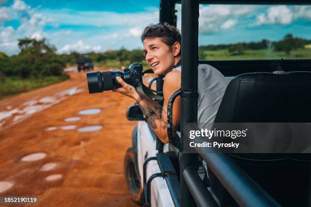 young man on safari journey by off-road car in sri lanka. - safari stockfoto's en -beelden