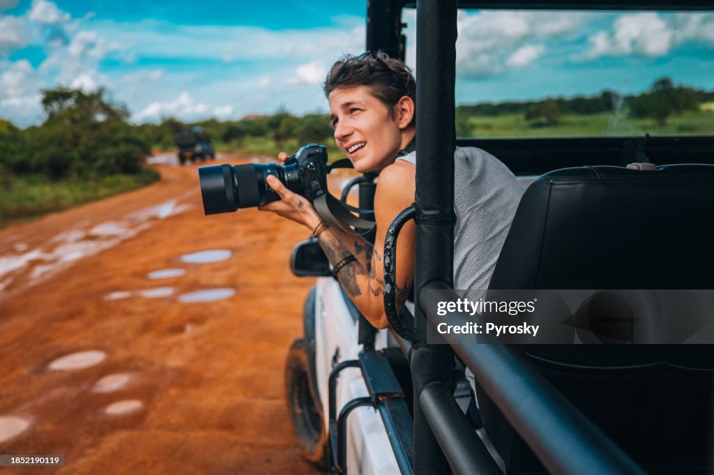 Young man on safari journey by off-road car in Sri Lanka.