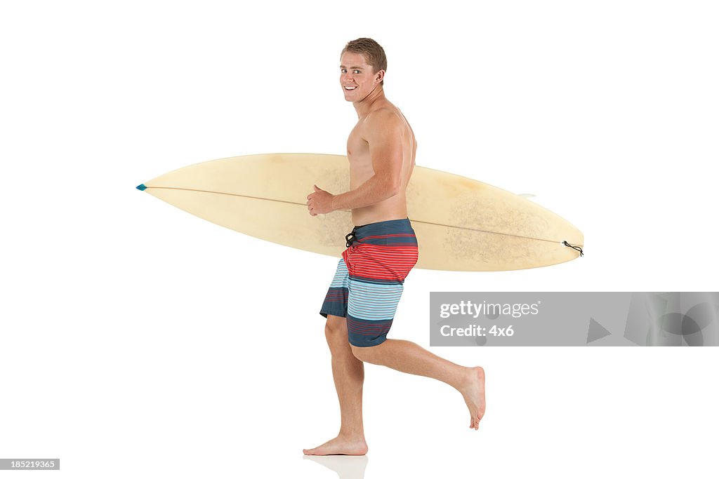 Man running with a surfboard