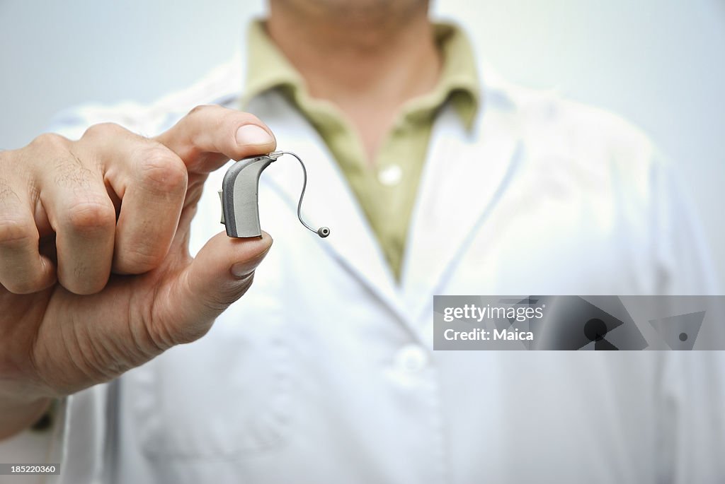 Doctor showing hearing aid