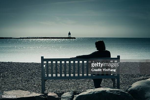 lone woman, widowed, divorced, or lonely, contemplating grief, sadness, depression - mourning stock pictures, royalty-free photos & images