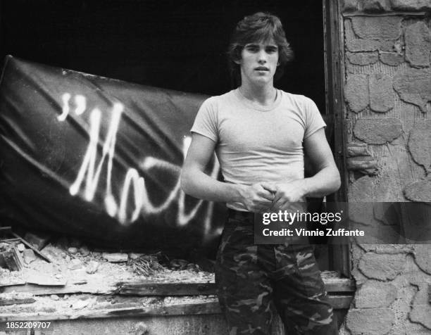 American actor Matt Dillon, wearing a light t-shirt with camouflage trousers, United States, circa 1980.