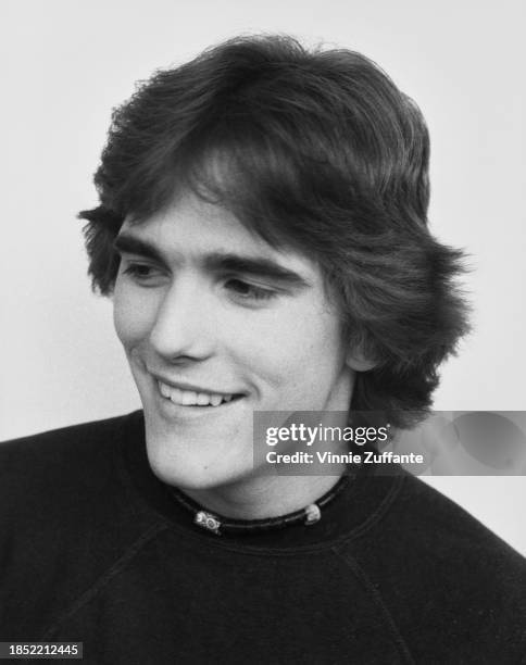 American actor Matt Dillon, wearing a dark crew neck t-shirt with a Native American choker-style necklace, United States, circa 1985.