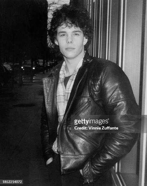 American actor Kevin Dillon wearing a black leather jacket over a checked shirt, United States, circa 1985.