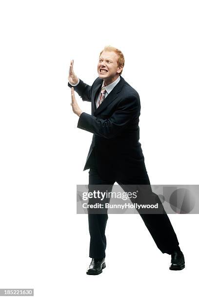 funny businessman holds up a wall on white - mime stock pictures, royalty-free photos & images