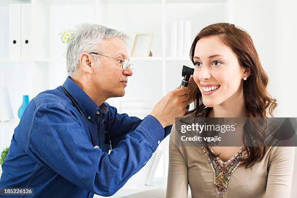 doctor doing ear exam with otoscope - ear exam stock pictures, royalty-free photos & images
