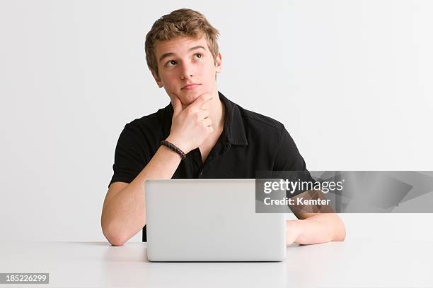 pensive student at working on laptop - writing email stock pictures, royalty-free photos & images