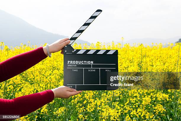 clapper board with hand - film crew stock pictures, royalty-free photos & images