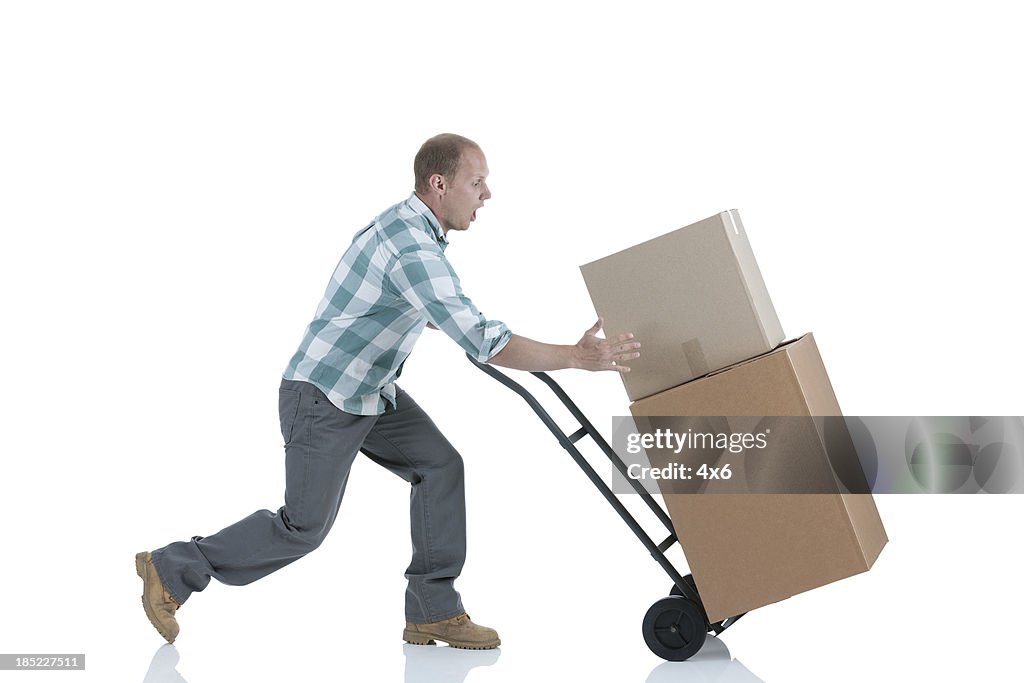 Man carrying cardboard boxes in a warehouse