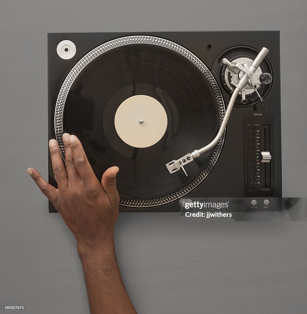 African American Hand spinning record on turn table
