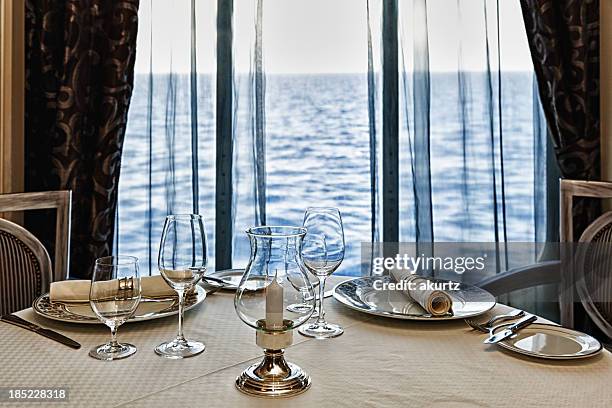 fine dining restaurant table set for two with ocean view - dining room set stock pictures, royalty-free photos & images