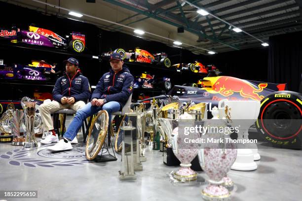 Sergio Perez of Mexico and Oracle Red Bull Racing and Max Verstappen of the Netherlands and Oracle Red Bull Racing look on surrounded with trophies...